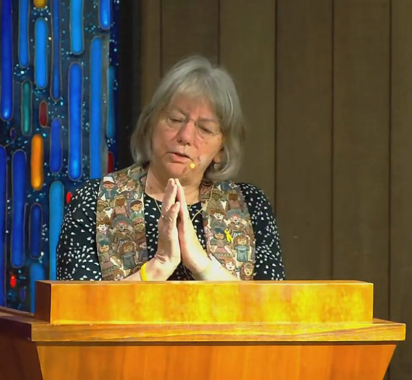 Pastor Vickie preaching at the pulpit